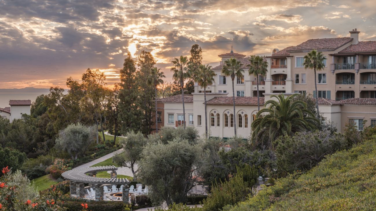 Exterior of Marriott's Newport Coast Villas resort timeshare with sun setting over water